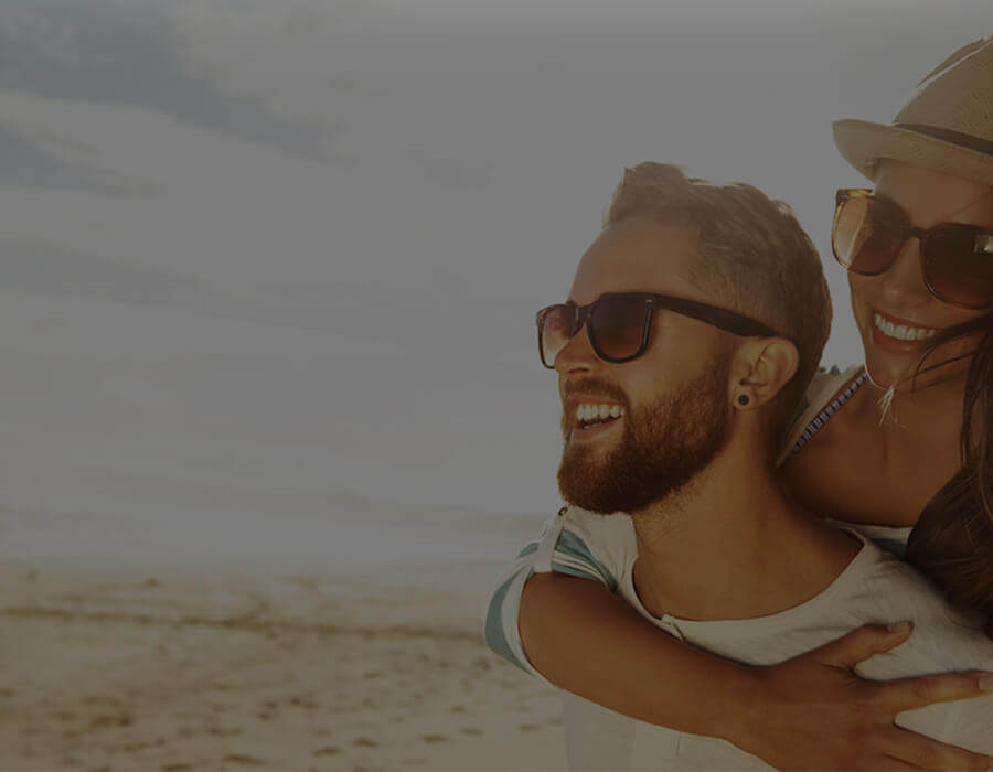 Man and Woman smiling at the beach