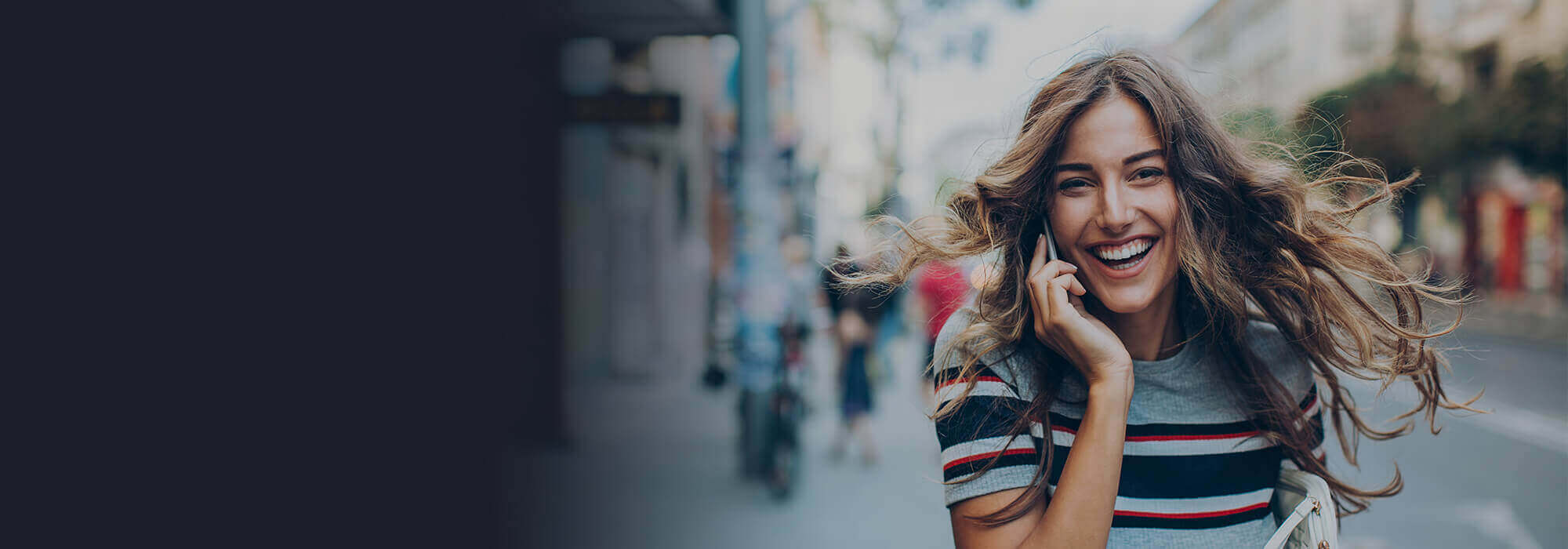 woman smiling whilst on mobile