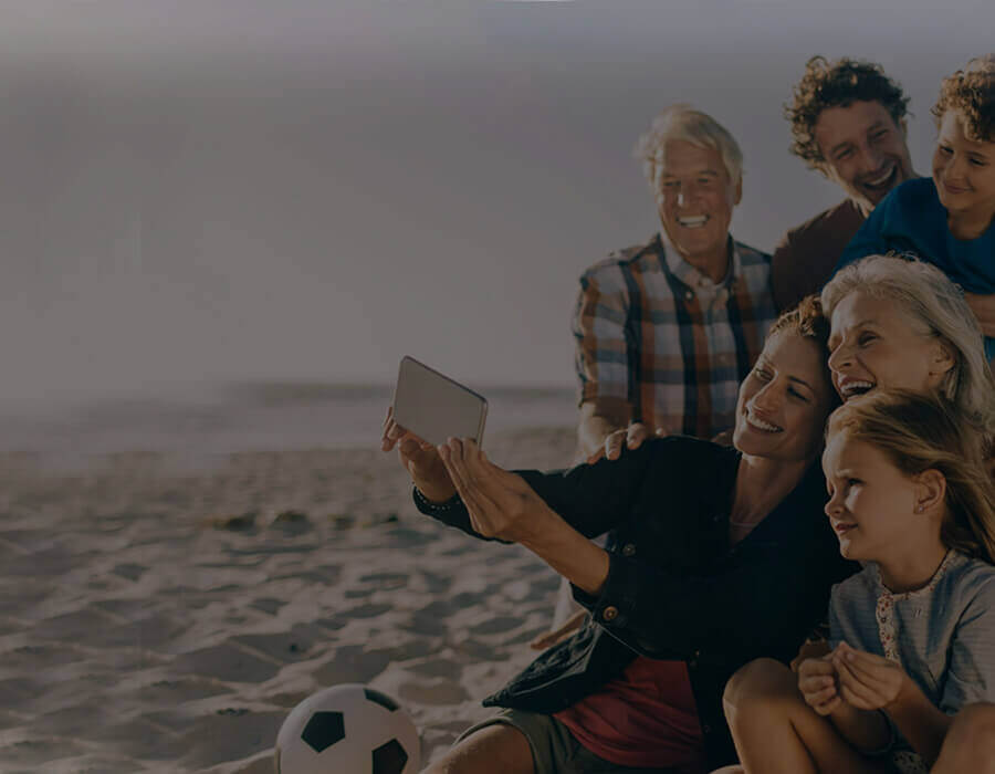 family taking picture at the beach
